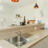 Apartment 2, © Ines Nejedly Modern kitchen with wooden worktop, sink and decoration.