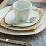Apartment 1, © Ines Nejedly Table set with white crockery, cup and cutlery.