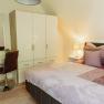 Apartment 2, © Ines Nejedly Bedroom with double bed, closet, dressing table and lamp.