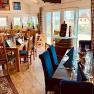 Dine in the cozy Gasthof zur Venus, © Familie Mistelbauer Dining room with wooden tables and wooden armchairs