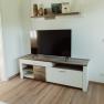 Apartment 1, © Ines Nejedly Living room with TV on a white TV cabinet, above a shelf with decorations.