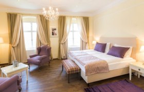 Baroque country farm Burkhardt, © Burkhardt Elegant bedroom with double bed, purple accents and chandelier.