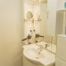Apartment 2, © Ines Nejedly Modern bathroom with washbasin, mirror, hairdryer and white cupboards.