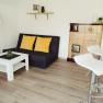 Apartment 2, © Ines Nejedly Modern living room with sofa, coffee table, bar stools and fireplace.