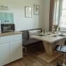 Apartment 2, © Ines Nejedly Modern kitchen with dining table, chairs and coffee machine.