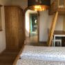 Room passage vacation at the Jauerling, © Romana Wiener Interior view of a room with wooden furniture and a passageway to a bathroom.