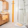 Bathroom, © Georg Pomassl Modern bathroom with wooden furniture, shower and orange accents.