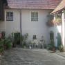 Inner courtyard of a traditional house with plants and seating area.