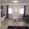 Living room with white furniture and gray couch