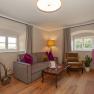Elegant suite with sofa, armchair, table and decoration.