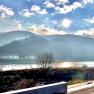 Sunbeams over a river with hills in the background.
