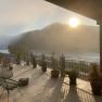 Terrace with a view of the river and mountains at sunrise.