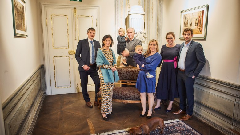 The Pichler family, © Familie Pichler A group of people pose in an elegant room with a dog in the foreground.