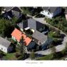 Aerial view of a residential area with several houses, including a house with a red roof.