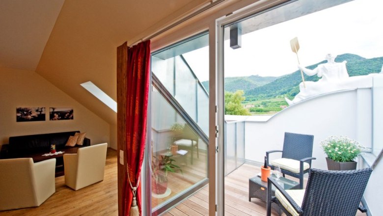 Interior view of a suite with balcony at Gasthof Prankl, view of the mountains.