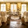 State Hall in Luberegg Castle with decorated chairs, carpet and murals.