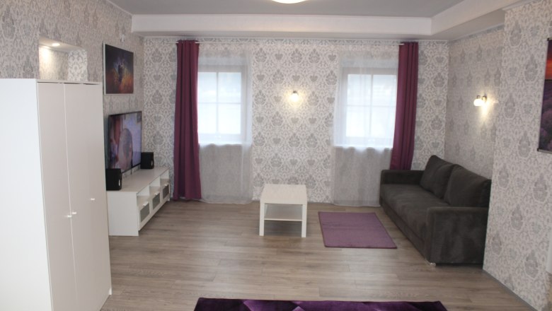 Living room with white furniture and gray couch